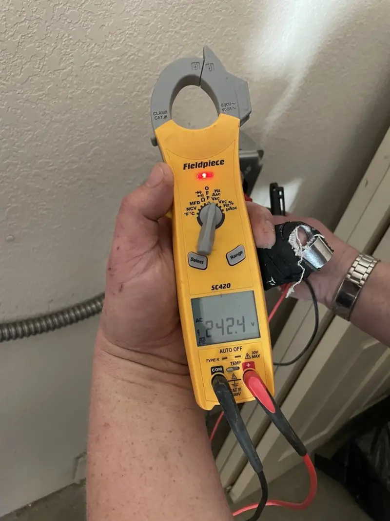 Voltage testing with clamp meter during Electrical Installation Services in Doral